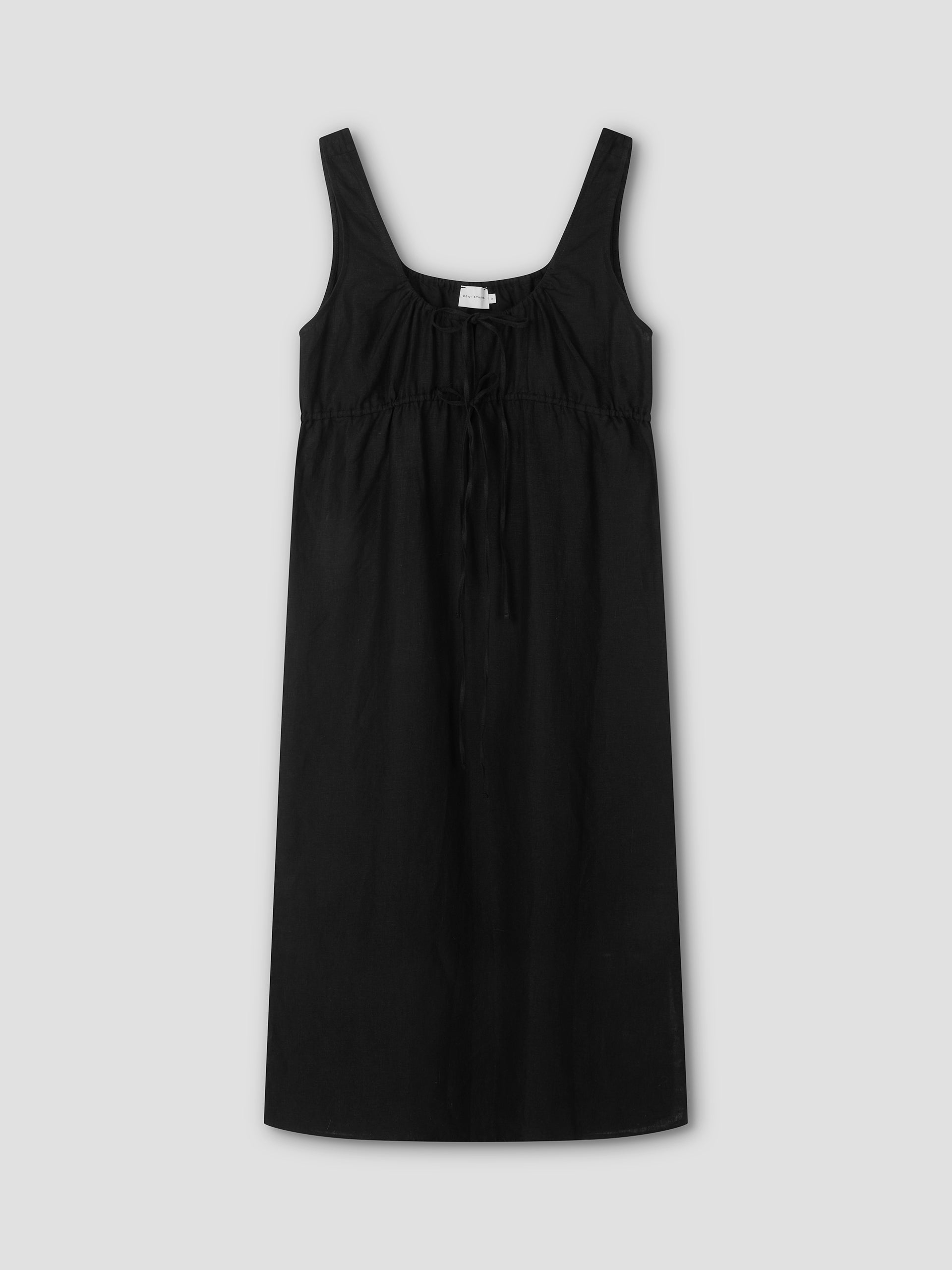 The Sleeveless Cord Dress - Black is a relaxed midi dress with a square neckline, empire waist, and an adjustable gathered drawcord at the chest, shown against a plain light gray background.