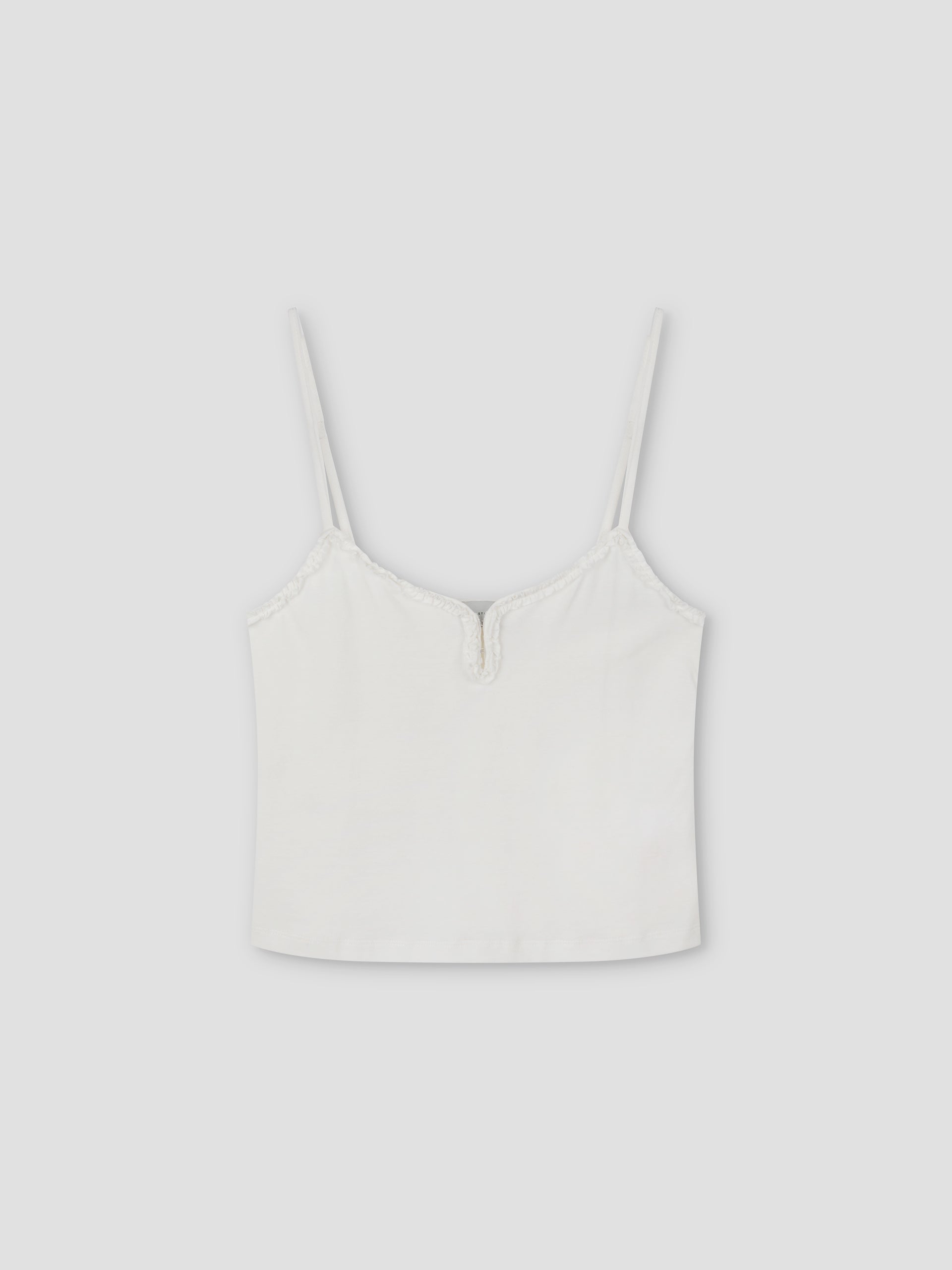 Clasp Singlet: White spaghetti strap crop top with a subtle V-shaped notch at the neckline, shown on a plain light gray background.