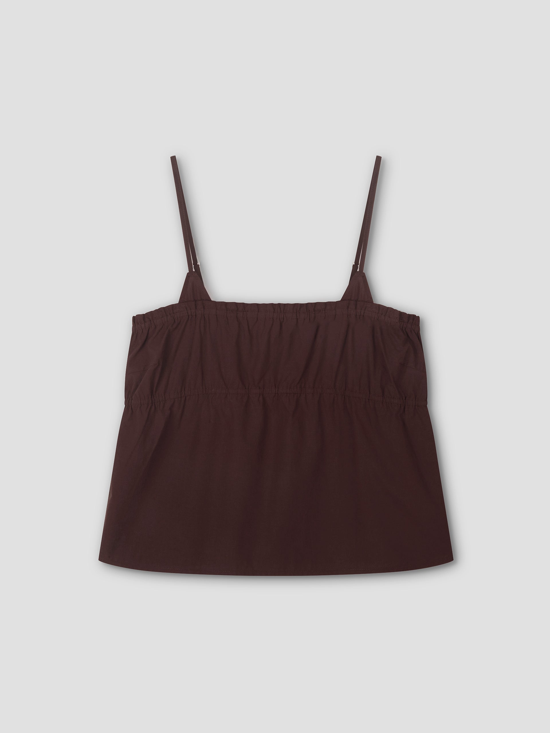 The Tri Cami - Sepia is a dark brown, sleeveless cami top with thin adjustable straps and an elasticized gathered chest, offering a relaxed silhouette. Shown laid flat on a light gray background.