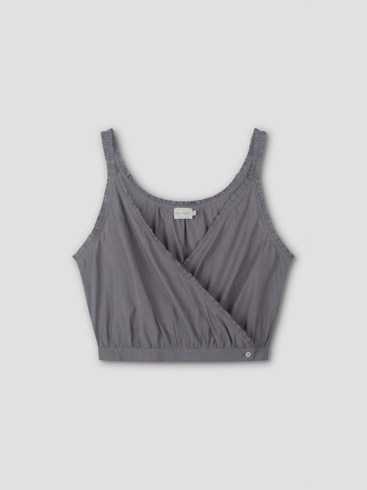 The Overlie Top - Currant is a sleeveless crop top from Deiji Studios in currant, featuring a scoop neckline, ruffled edges, overlapping wrap-style front, layered silhouette, and elastic waist for comfort.