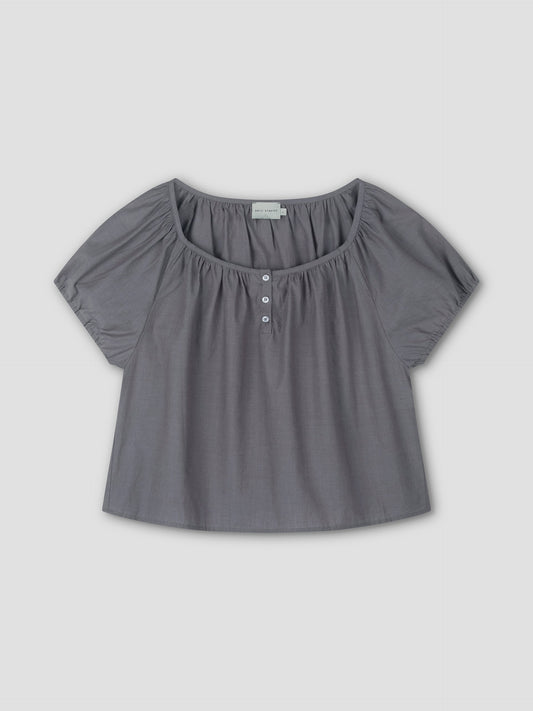 The Poplin T Shirt - Currant features short sleeves, a loose fit, wide scoop neckline, cropped silhouette, and three white front buttons. Made from soft, lightweight fabric and shown on a flat light gray background.