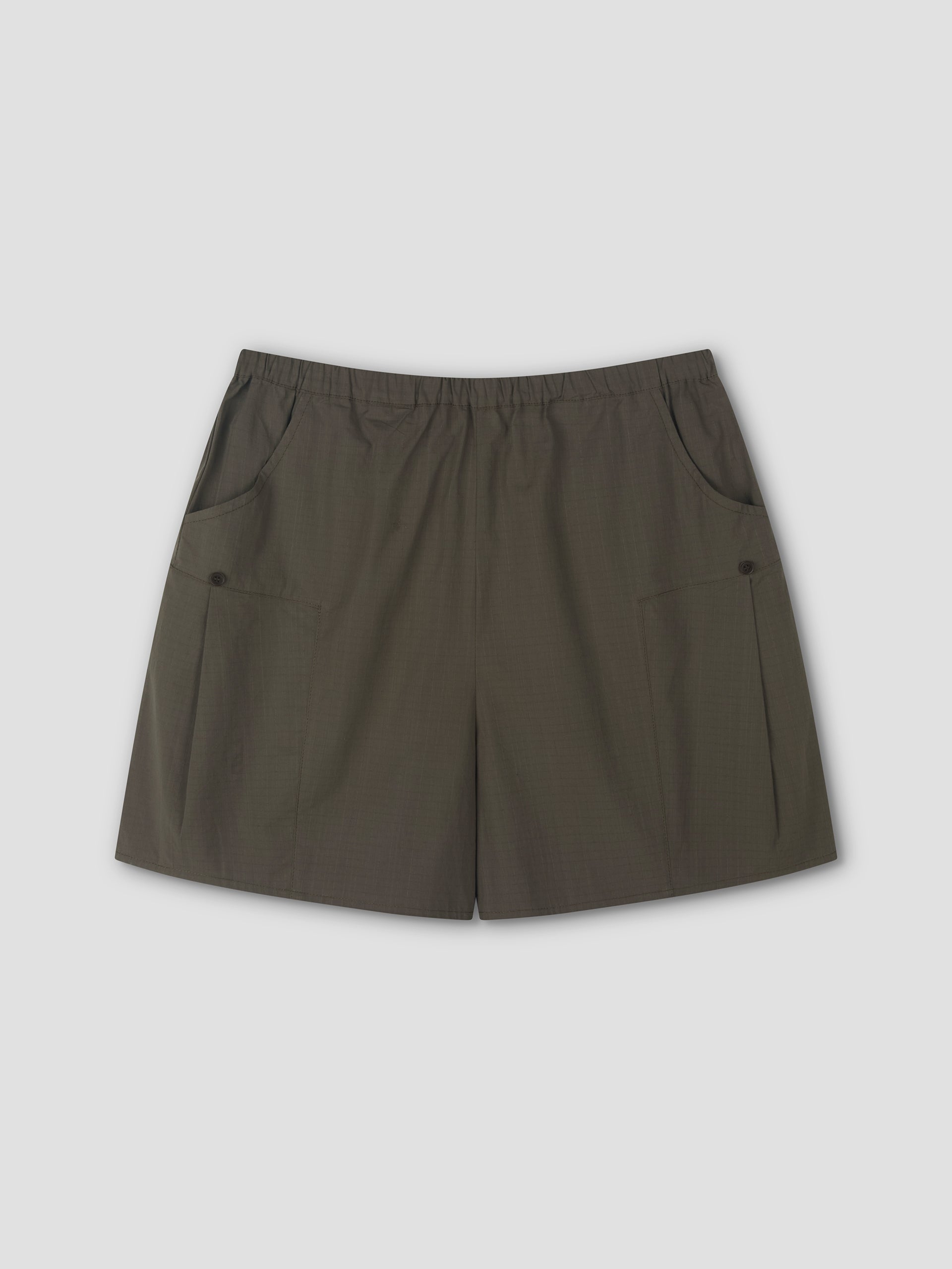 A pair of Deiji Studios Pleat Short - Khaki Check with an elastic waistband and two front pockets, laid flat on a light gray background.