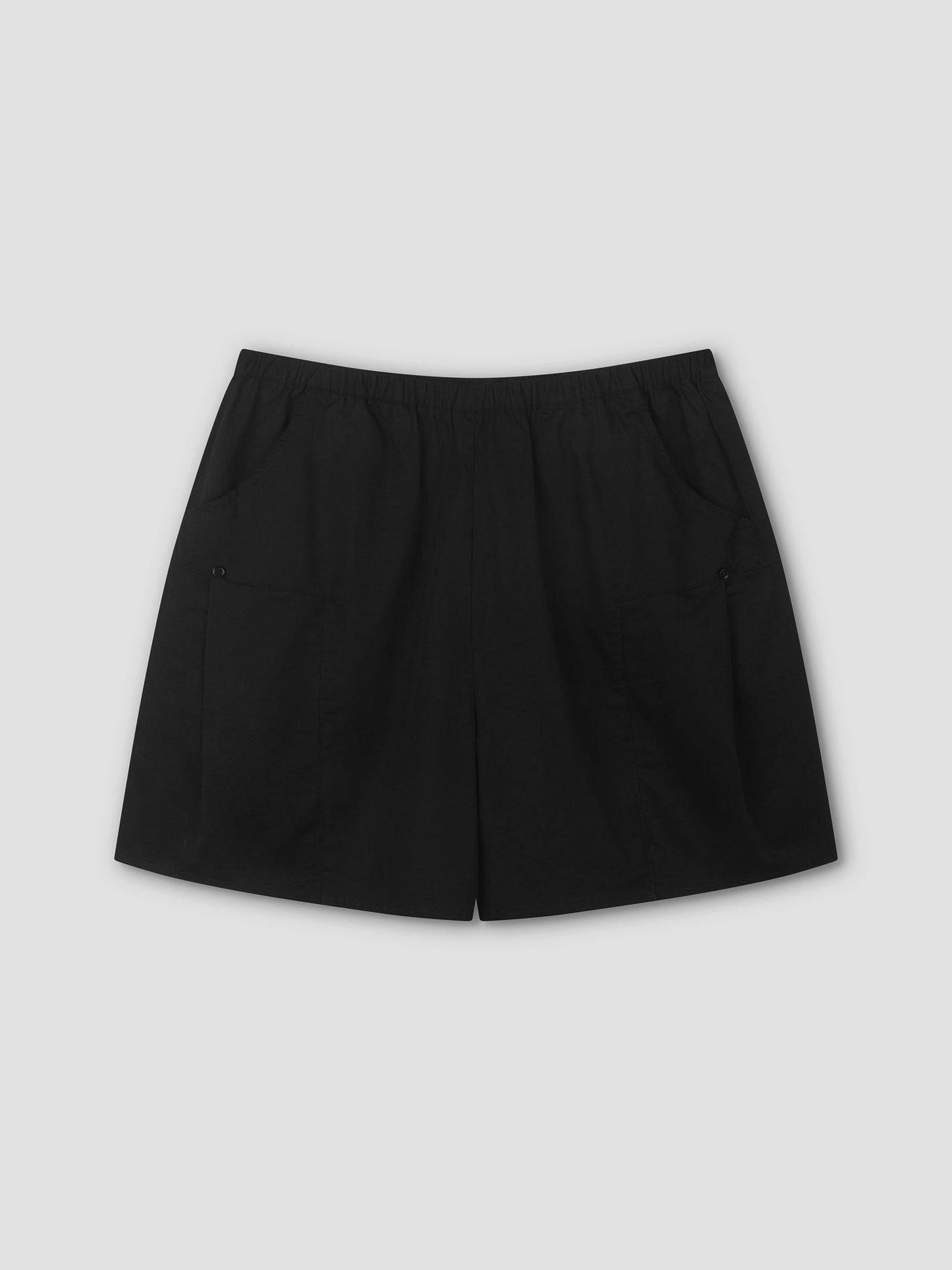 Pleat Short - Black by Deiji Studios, shown flat on a light gray background, features an elastic waistband, two front pockets, and a relaxed mid-rise fit for comfortable everyday style.