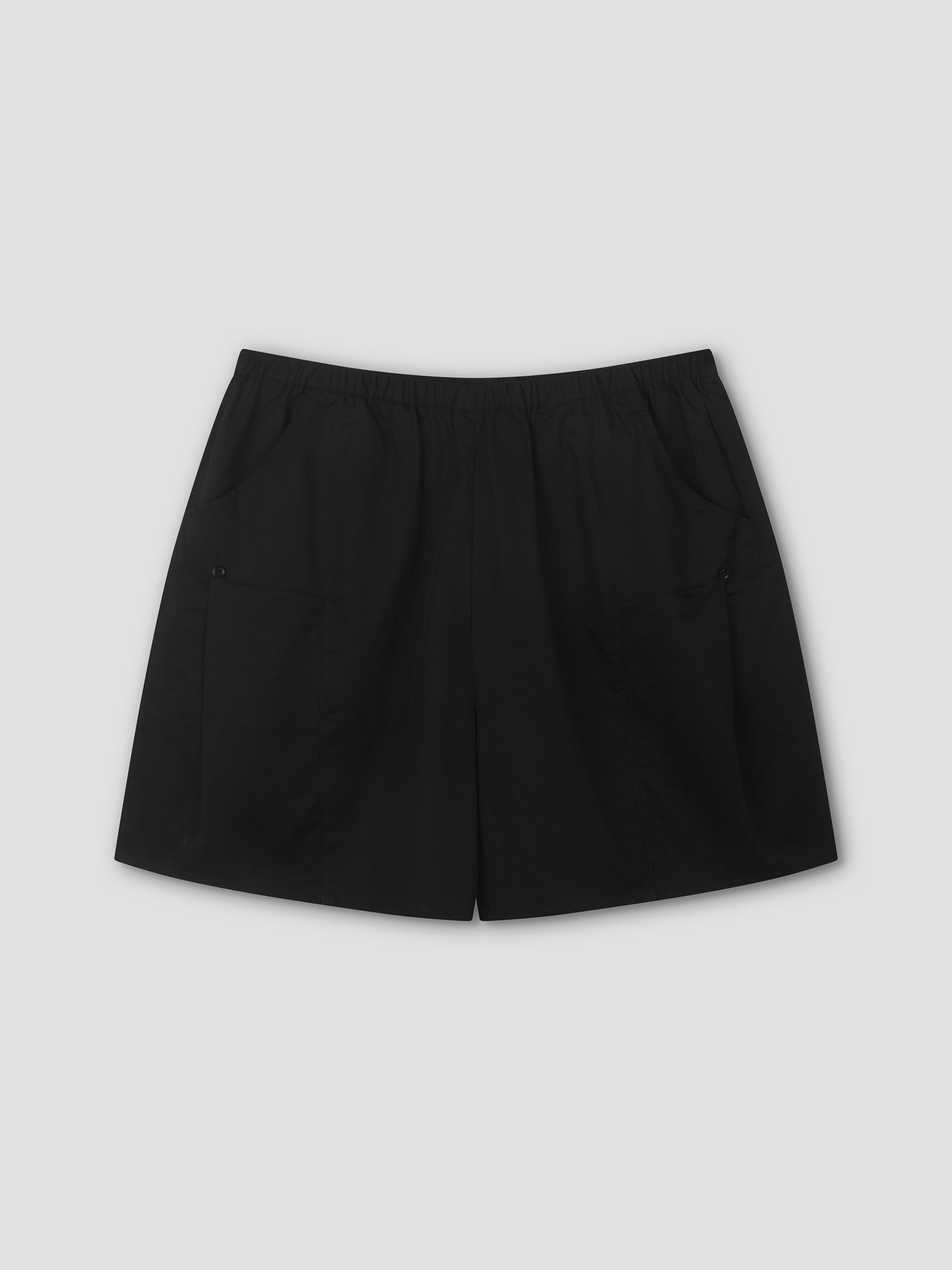 Pleat Short - Black by Deiji Studios, shown flat on a light gray background, features an elastic waistband, two front pockets, and a relaxed mid-rise fit for comfortable everyday style.