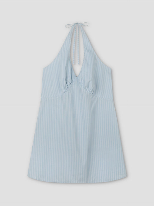 The Cinched Halter Dress - Lake Blue Stripe by Deiji Studios features light blue and white vertical stripes, a deep V-neckline, neck tie, and cinched waist, shown flat on a plain light background.
