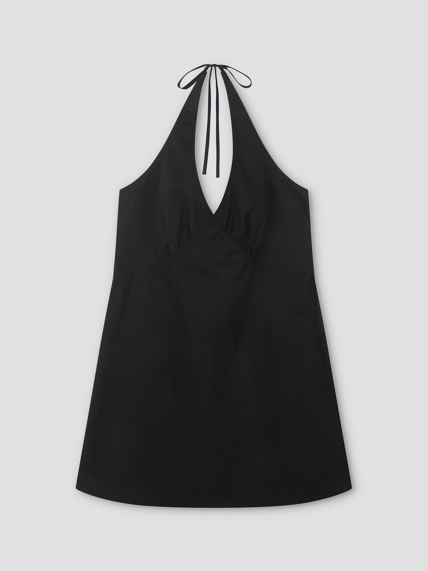 The Cinched Halter Dress - Black is a lightweight dress with a deep V-neckline and slight hem flare, shown laid flat on a light gray background.