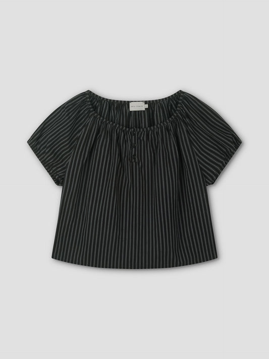 The Poplin T Shirt - Mono Stripe is a black short-sleeve blouse with white stripes, a loose fit, elastic gathered neckline, and center tie, styled like Deiji Studios. It’s displayed flat on a light gray background.