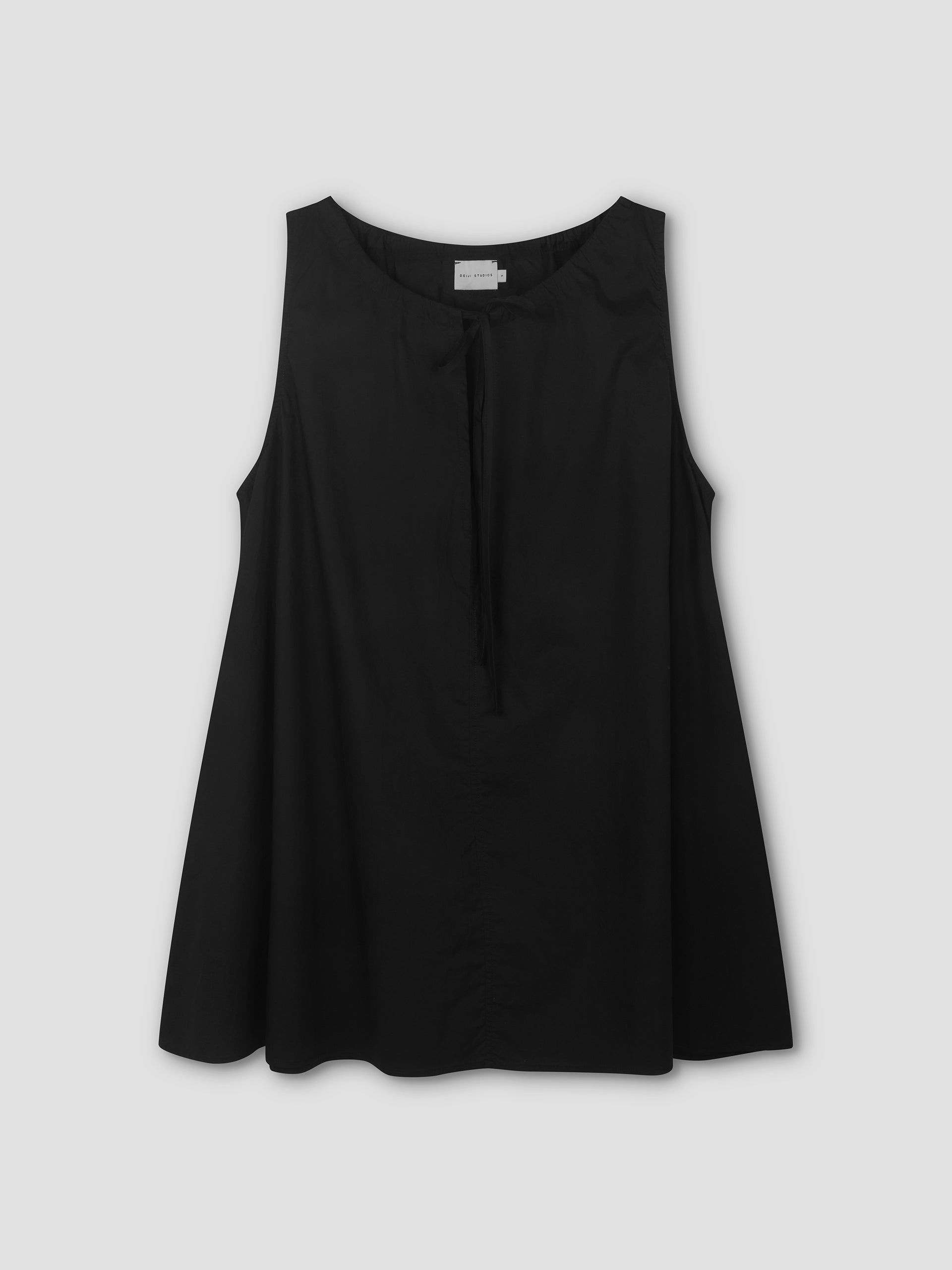 Sleeveless Drawcord Dress in black featuring an A-line silhouette and a tie detail at the neckline, inspired by Deiji Studios' minimalist style, shown against a plain light gray background.