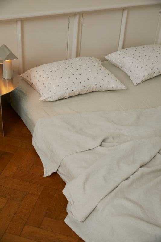 Light room with queen bed topped with Sheets - Oatmeal by Deiji Studios