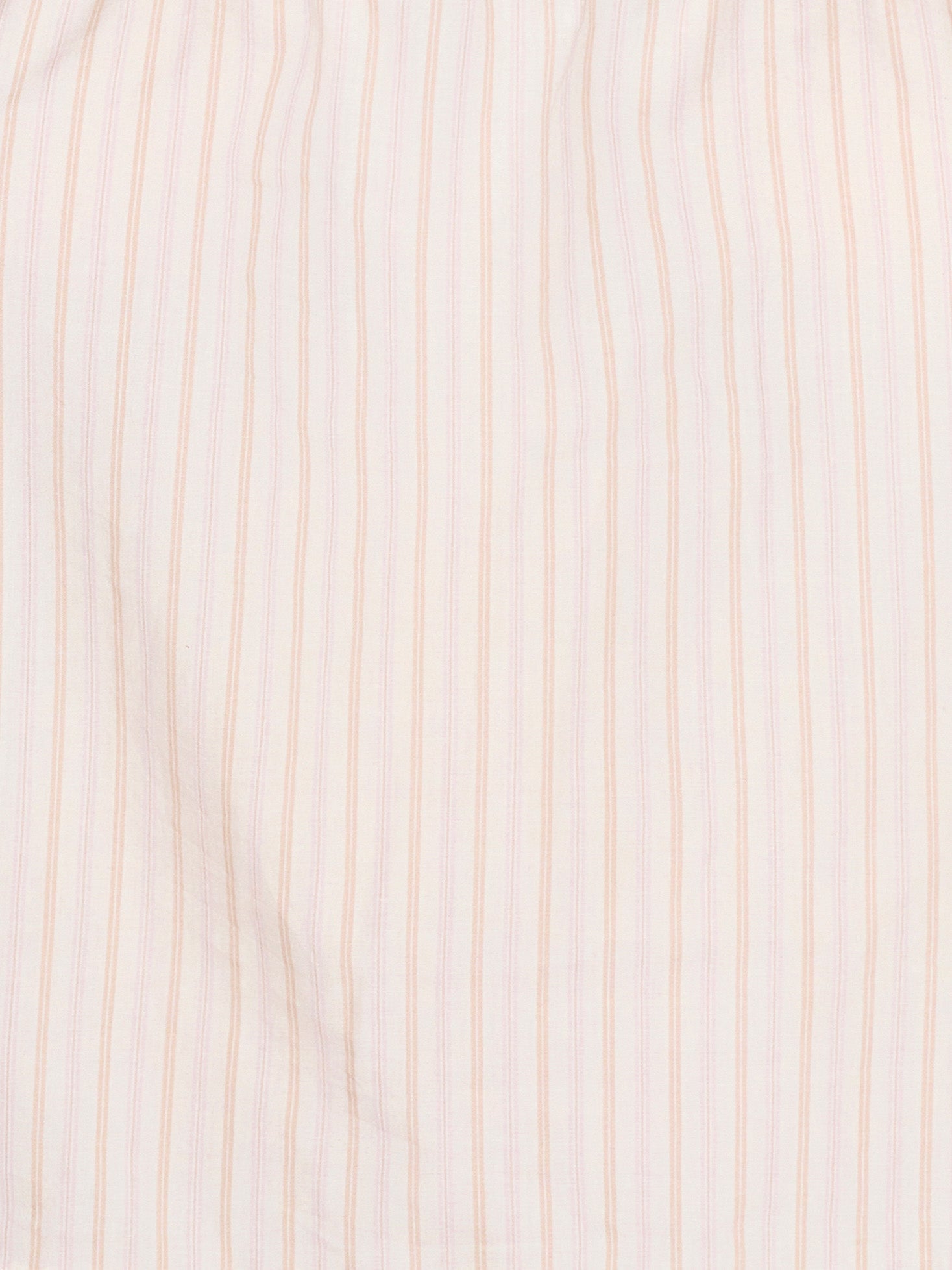 Close-up of the Simple Top - Dusty Stripe by Deiji Studios, crafted from organic cotton in white with evenly spaced, thin dusty pink vertical stripes. The fabric looks soft, slightly wrinkled, and breathable.