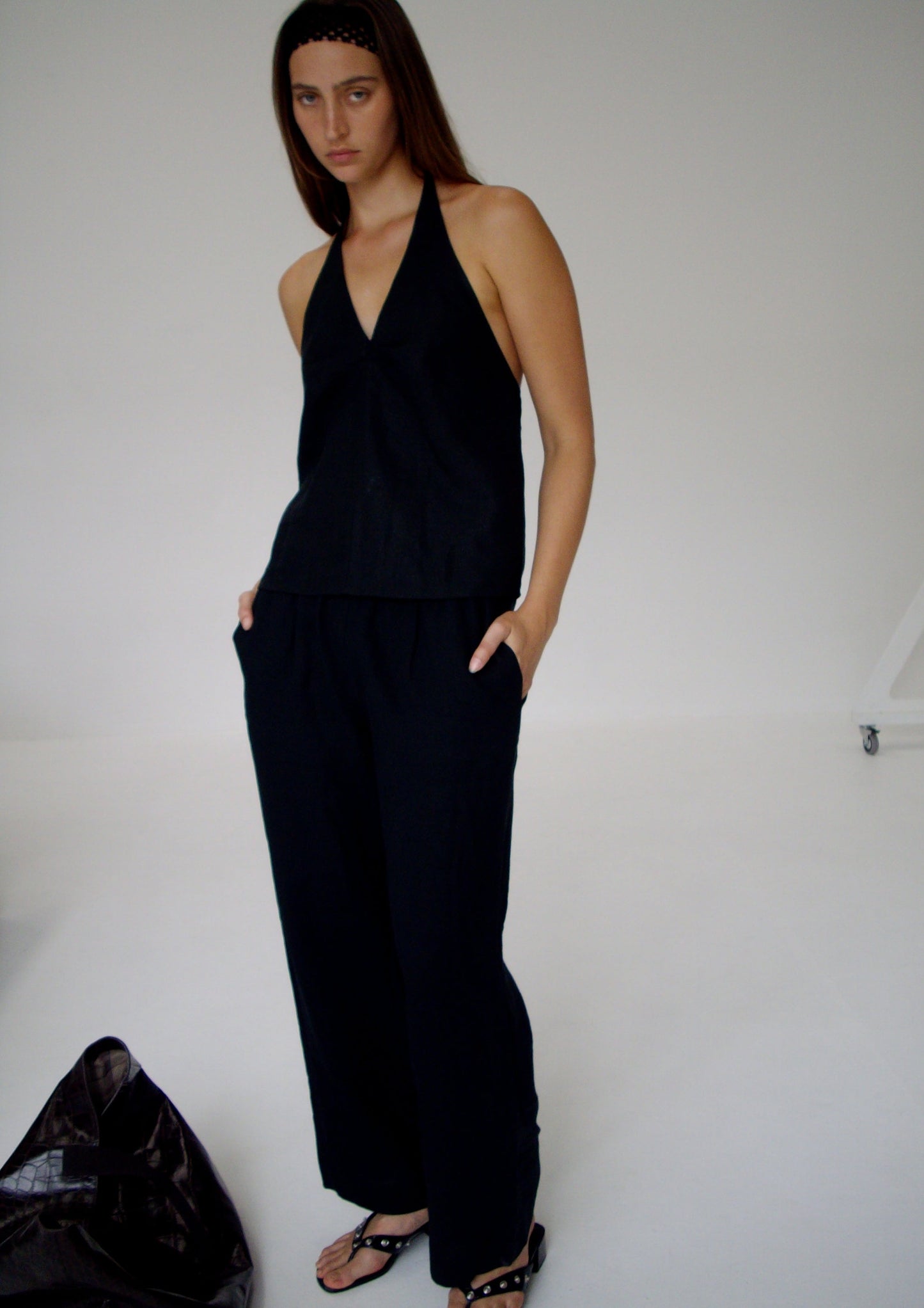 female model wears the linen ease trouser by Deiji Studios in black


the ankle length pant features a soft minimal elastic waist with side seam pockets in a straight leg


can be worn at home, in bed, or out

made from 100% GOTS certified organic, OEKO-TEX 100 certified and EU certified stone washed french linen

paired with a black linen halter top