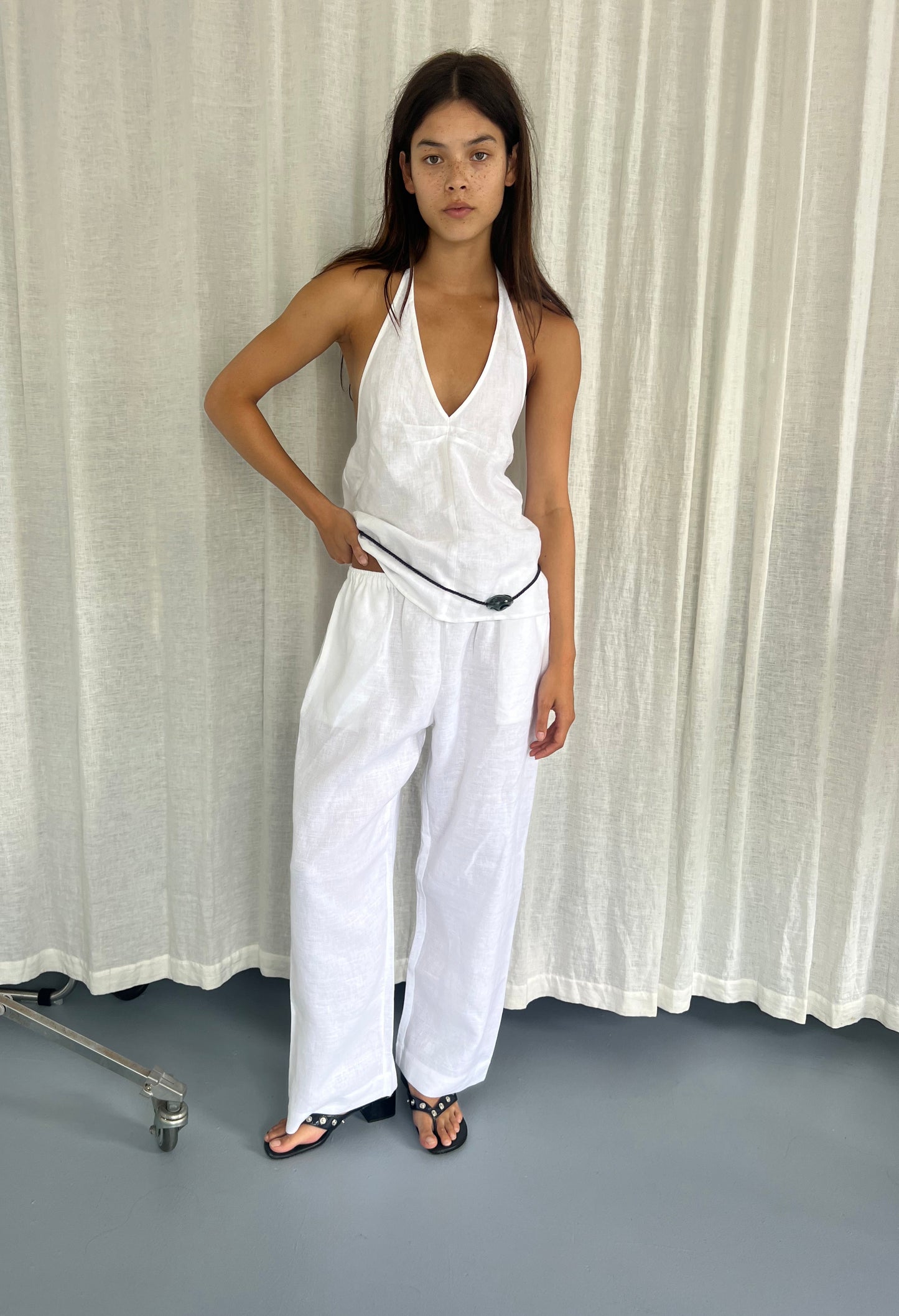 female model wears the linen ease trouser by Deiji Studios in white


the ankle length pant features a soft minimal elastic waist with side seam pockets in a straight leg


can be worn at home, in bed, or out

made from 100% GOTS certified organic, OEKO-TEX 100 certified and EU certified stone washed french linen

paired with a white linen halter top