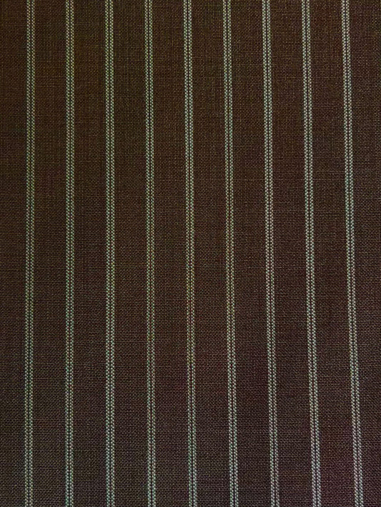 The Folded Wool Pant - Sable Stripe by 0 features evenly spaced white pinstripes on textured RWS wool, offering a timeless, slightly coarse look.