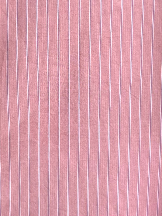 Close-up of the Arch Tie Shirt - Salt Stripe by 0, made from pink organic cotton poplin featuring thin, evenly spaced vertical white stripes and a soft texture—ideal for its boxy fit design.