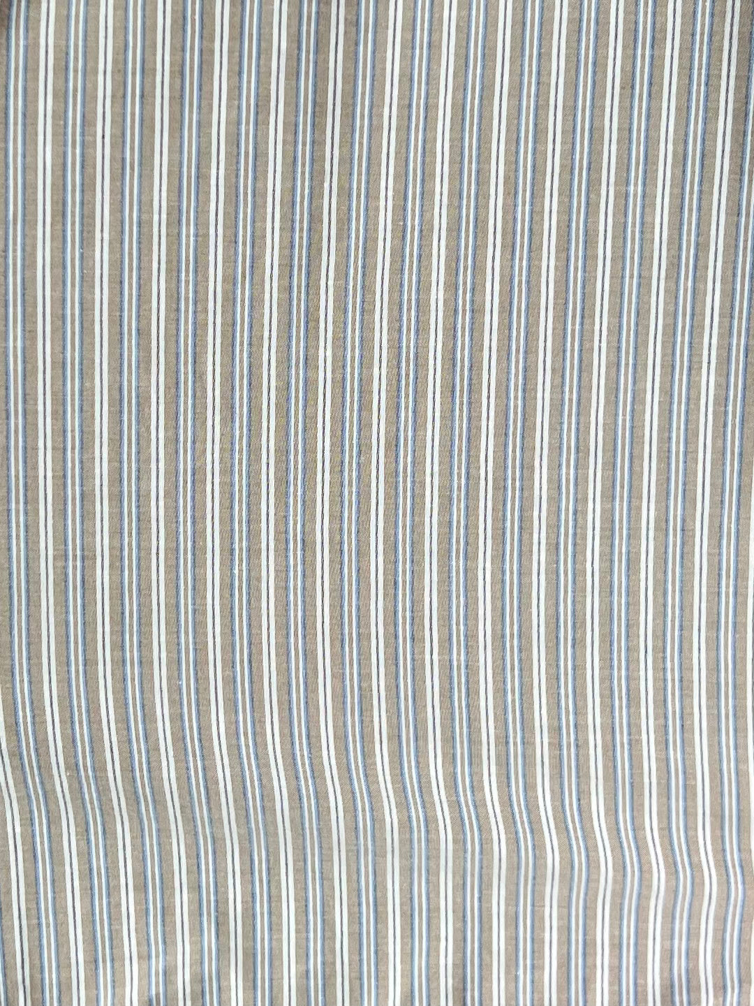 The Ruffle Mini Skirt - Seas Stripe features vertical stripes in beige, white, and light blue on organic cotton with a slight texture, creating a soft, airy look ideal for this Deiji Studios design.