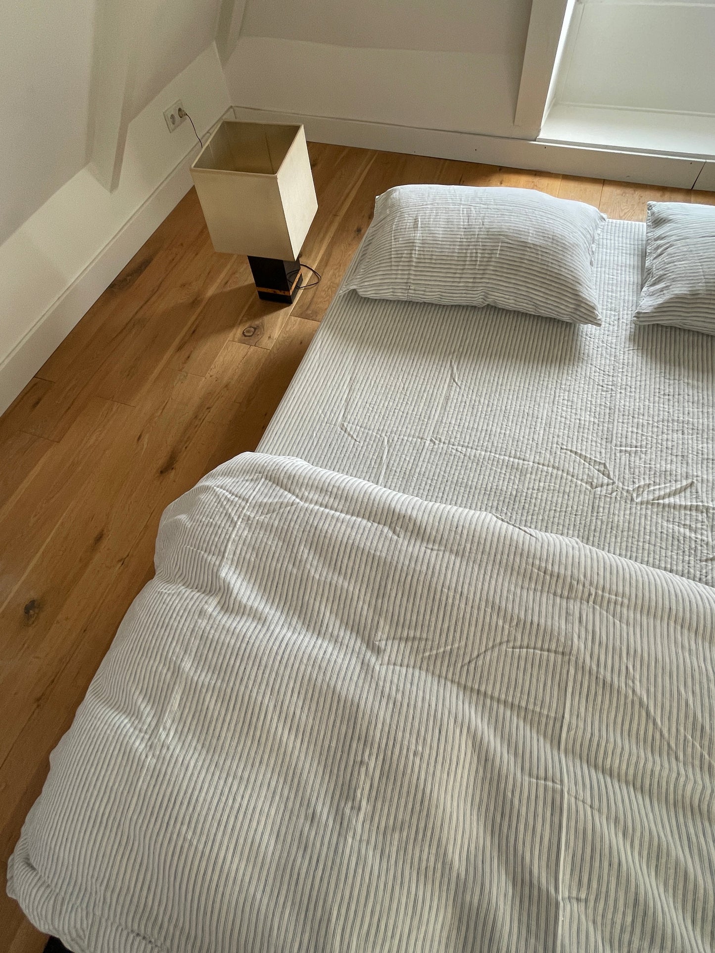 Light room with queen bed topped with Duvet cover - River Stripe by Deiji Studios