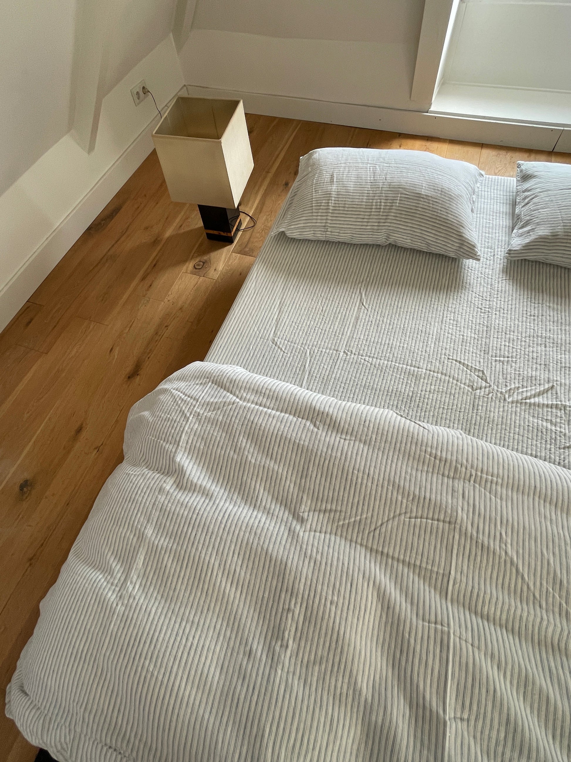 Light room with queen bed topped with Duvet cover - River Stripe by Deiji Studios