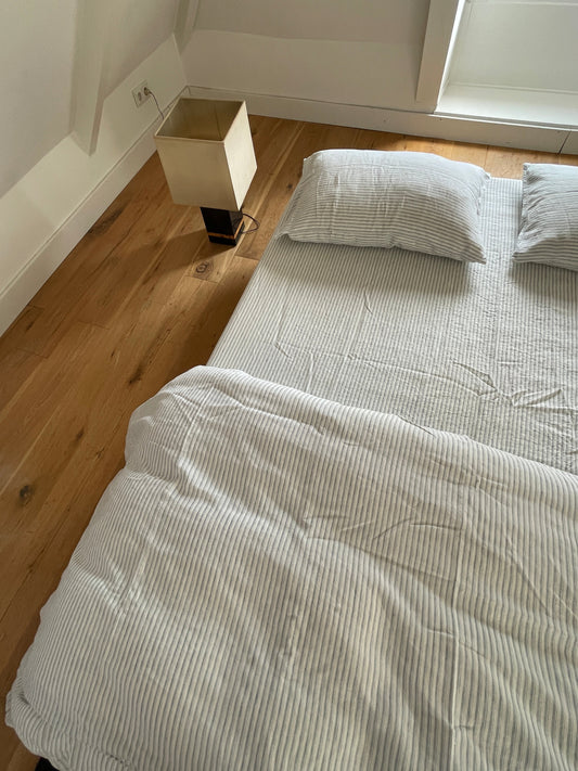 Light room with queen bed topped with Duvet cover - River Stripe by Deiji Studios