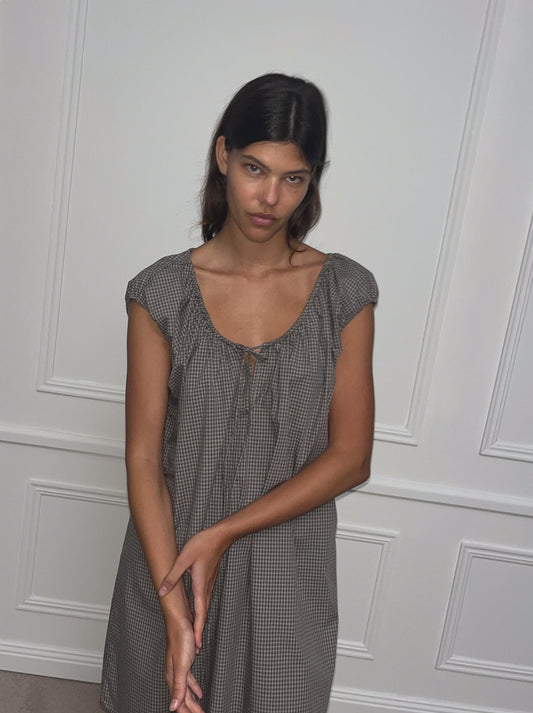 Female model wearing Capped Sleeve Dress - Khaki Check by Deiji Studios against plain background