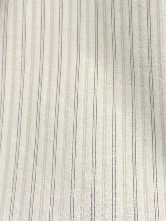 Close-up of the Button Skirt - Pacific Stripe, featuring white fabric with subtle beige and gray vertical stripes. This lightweight woven textile has a delicate ticking stripe pattern and a naturally soft, slightly wrinkled texture.