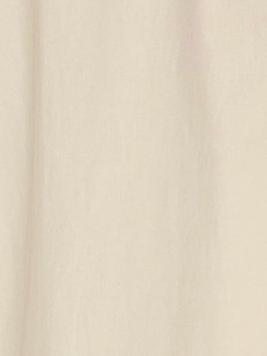 A close-up of the Light Dress - Butter White, made from light beige organic cotton with soft, vertical folds and a smooth texture.