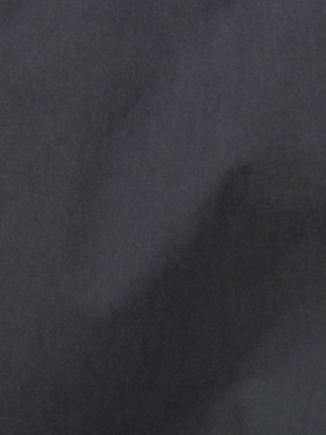A close-up of the Two Layer Pant - Charcoal shows its dark gray, subtly textured surface with soft shading, evoking the cloud-like look of organic cotton by Deiji Studios.
