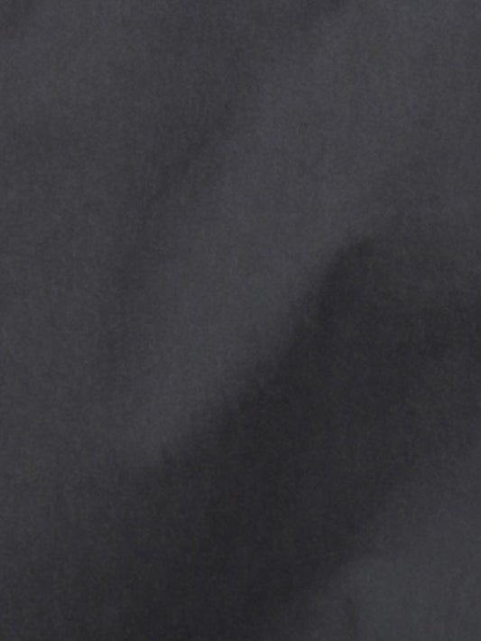 A close-up of the Two Layer Pant - Charcoal shows its dark gray, subtly textured surface with soft shading, evoking the cloud-like look of organic cotton by Deiji Studios.