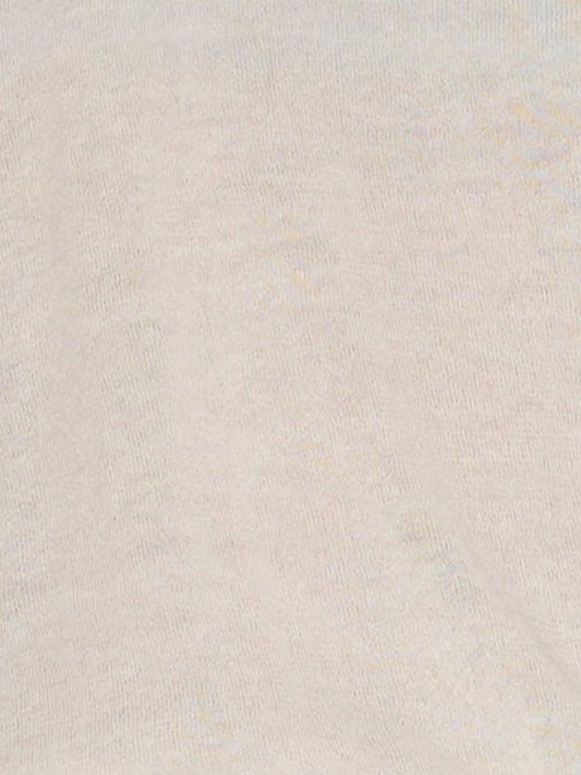 A close-up of the Rolled Knit Top in Off White shows its light beige textured knit, subtle weave patterns, and gentle folds.