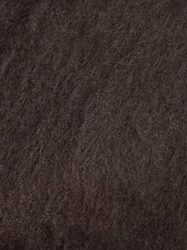 Close-up of the Belted Cardi - Brown shows dense, soft dark brown knit fabric with a textured, wavy pattern. The material evokes an oversized belted cardigan style with visible strands throughout.