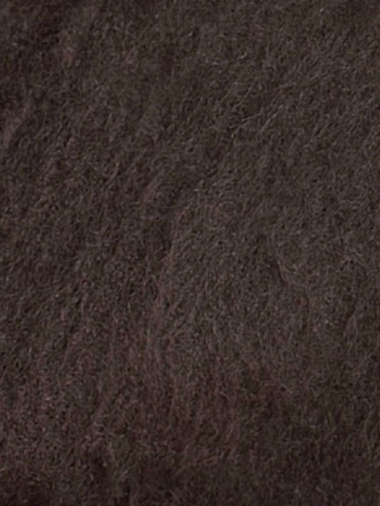 Close-up of the Belted Cardi - Brown shows dense, soft dark brown knit fabric with a textured, wavy pattern. The material evokes an oversized belted cardigan style with visible strands throughout.