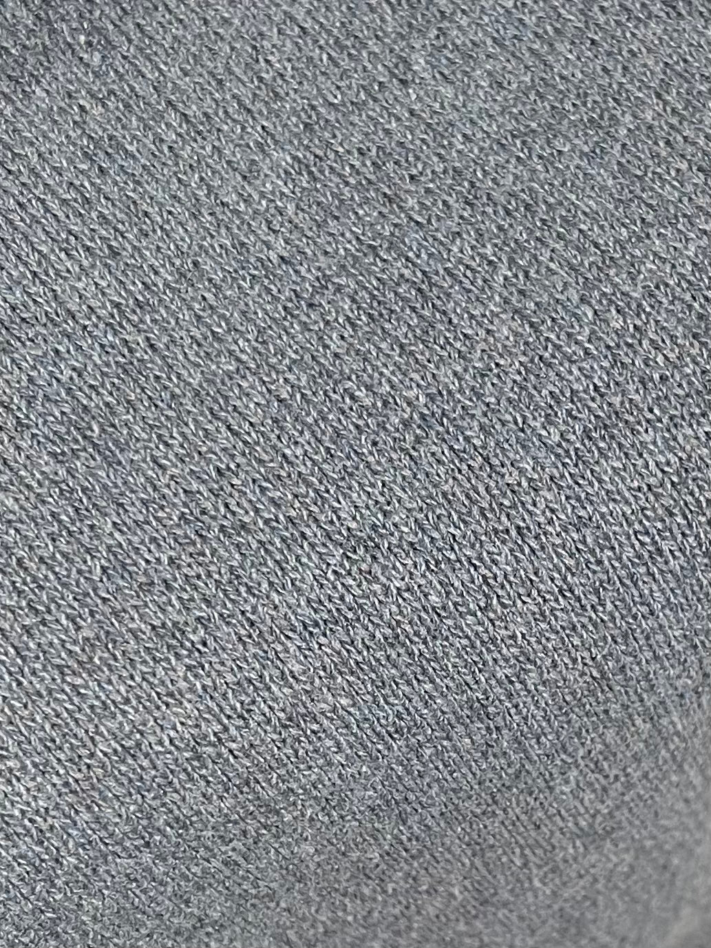Close-up of the Glacier Blue Pullover, highlighting its textured knit pattern with small, evenly spaced stitches.