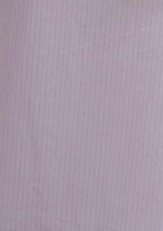 The Flounce Short - Lilac Stripe features light purple fabric with subtle vertical pinstripes, a smooth, slightly shiny texture, and an elastic waistline for comfortable, relaxed wear.