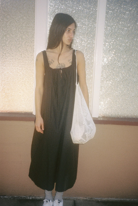 Female model wearing the paper dress - black by Deiji Studios against plain background