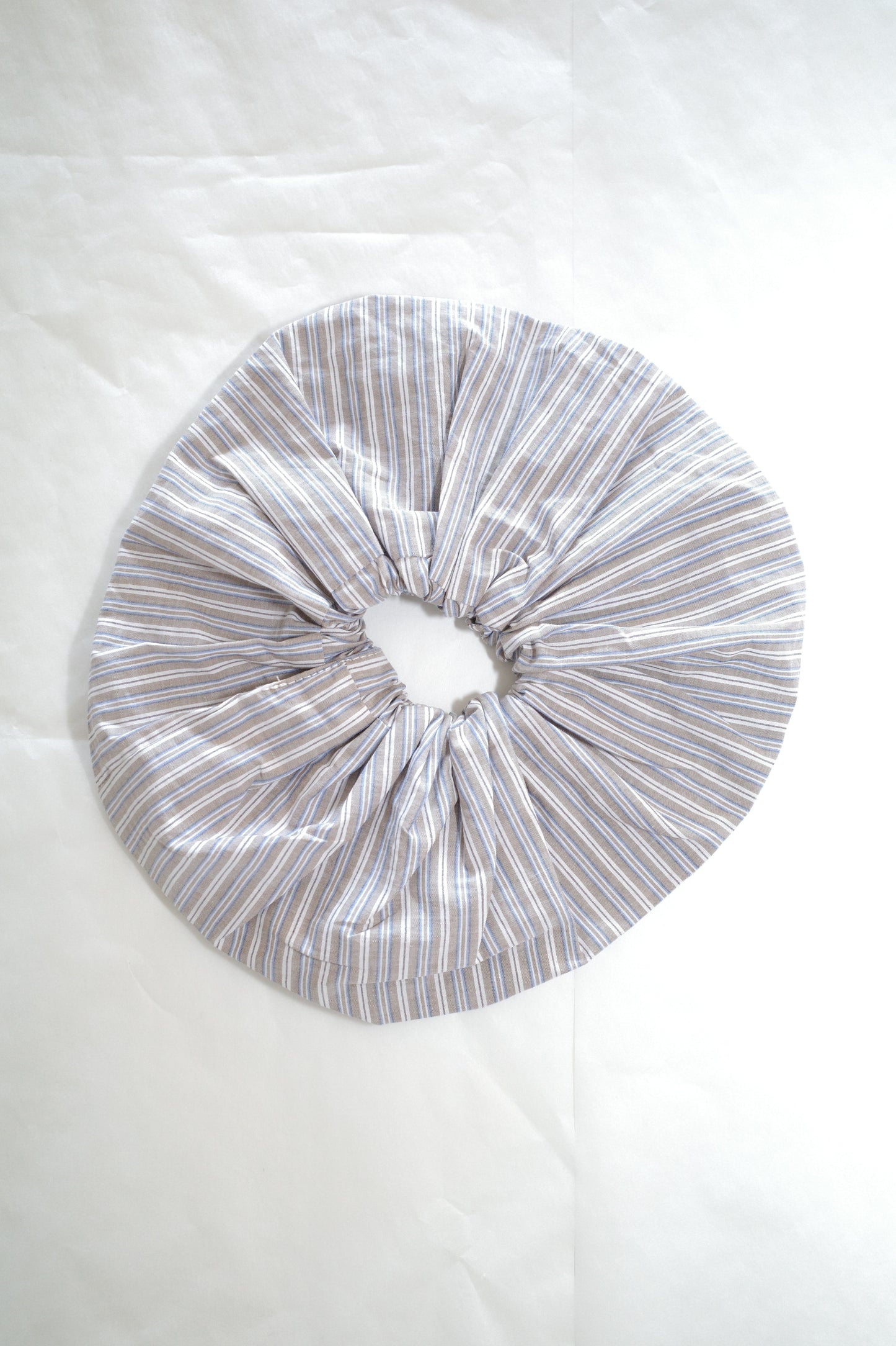 flat-lay image of the scrunchie by Deiji Studios in seas stripe

an oversized cotton elasticated scrunchie to be worn in hair or on wrist.

made from 100% organic cotton