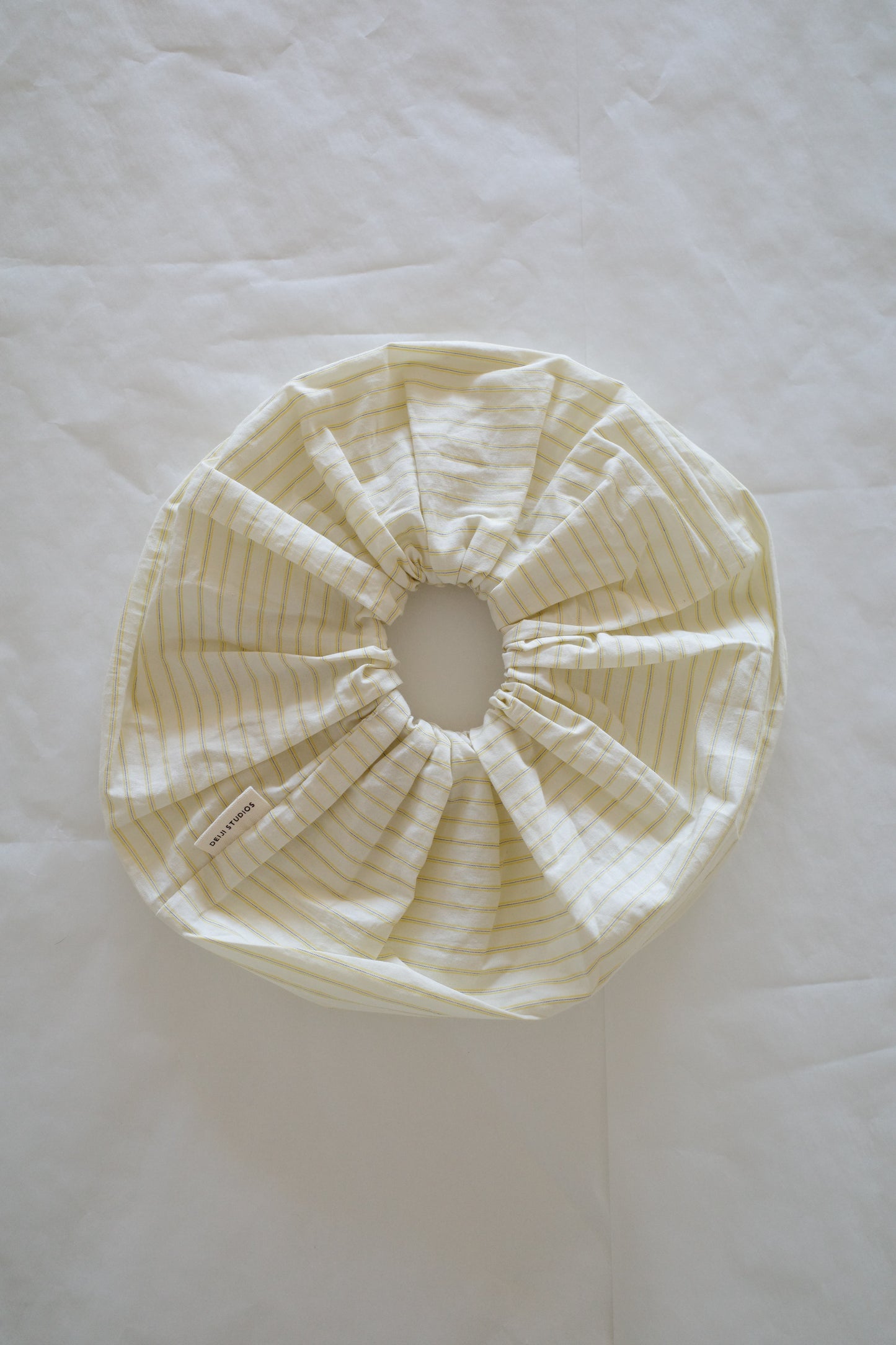 flat-lay image of the scrunchie by Deiji Studios in butter stripe

an oversized cotton elasticated scrunchie to be worn in hair or on wrist.

made from 100% organic cotton