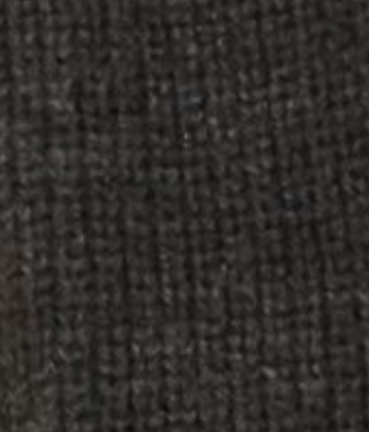 Close-up of the Flounce Cardigan - Charcoal by Deiji Studios, showing its dark, textured recycled knit with visible threads and a rugged surface in deep charcoal tones.