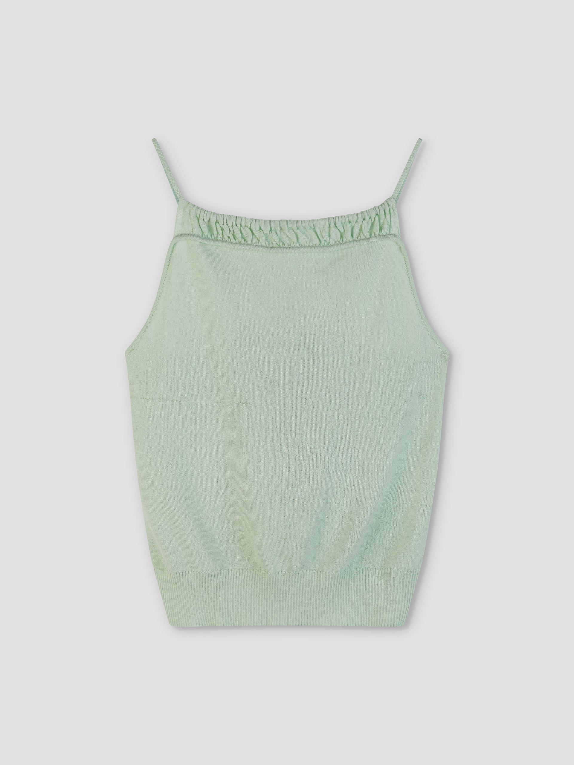 The Drawcord Knit Top - Mint by Deiji Studios features a light green sleeveless design with thin spaghetti straps, an adjustable ruched neckline, and ribbed hem, shown against a plain white background.