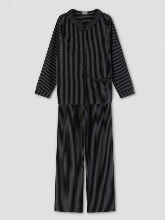 The Left Set - Mono Stripe features black pajamas with thin white stripes, including a lightweight, relaxed-fit long-sleeve button-up shirt and matching pants, displayed flat on a light gray background.