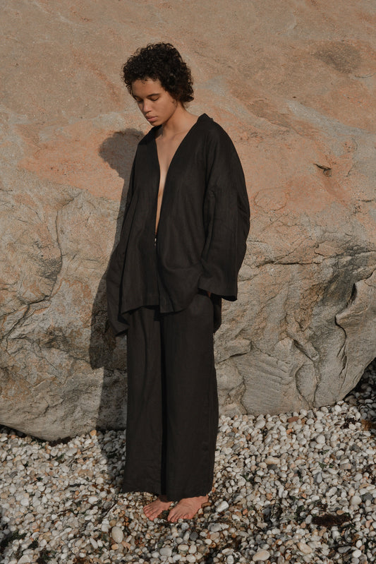 Female model wearing the 01 set - deep black by Deiji Studios against plain background