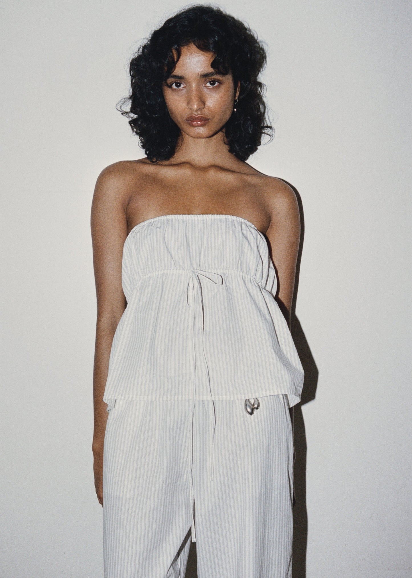Female model wearing Strapless Cotton Top - Story Stripe by Deiji Studios against plain background