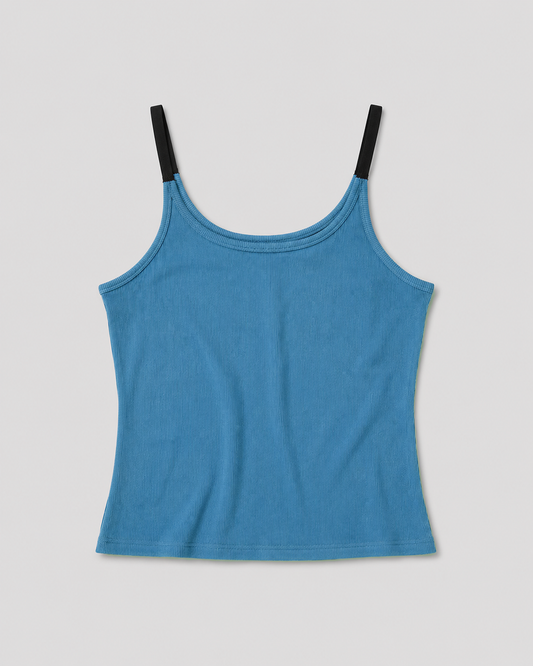 The Rib Jersey Tank - Azure is a blue fitted ribbed tank with thin black shoulder straps, displayed flat on a white background.